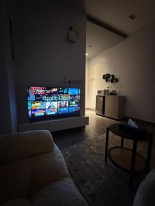 a living room with a large flat screen tv at شقق النخيل المخدومة in Al Kharj