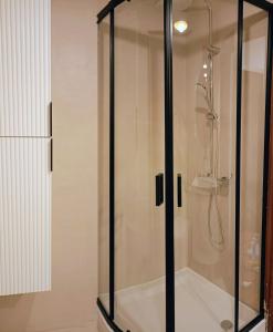 a shower with a glass enclosure in a bathroom at Kazimierz City Center Senatorska in Kazimierz Dolny +7 photos