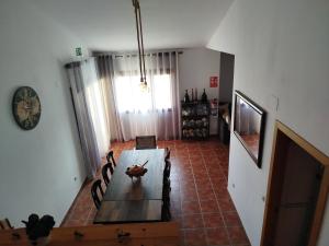 a dining room with a table and a television at El Torreón in Valderredible