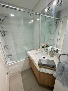 a bathroom with a large shower and a sink at Habitaciones privadas con vistas al parque in Lima +13 photos