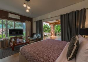 a bedroom with a bed and a living room at VANA Homestay in Ban Tai