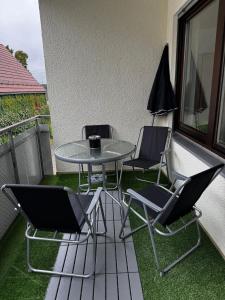 a table and chairs on a balcony with grass at Ferien und Monteurwohnung mit Garage im Gäu in Gäufelden