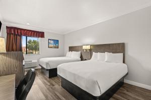 a hotel room with two beds and a window at Americas Best Value Inn Prescott Valley in Prescott Valley +8 photos