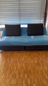 a blue bed with two laptops on top of it at Lugano Breve Soggiorno in Viganello
