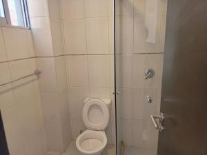 a bathroom with a toilet and a shower at Lyra in Cochabamba