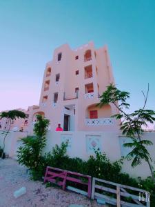 a white building with a fence in front of it at شاليهات مراسي للتنمية السياحيه in Marsa Matruh