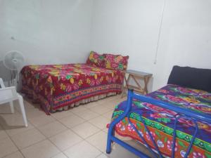 a room with a couch and a bed and a chair at El Pacifico in Juayúa