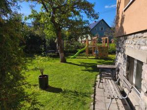 a bench sitting in a yard with a playground at Lipoffka in Lipova Lazne +47 photos