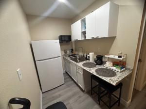 a small kitchen with a refrigerator and a sink at Cozy Stay in Tampa in Tampa +18 photos