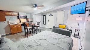 a living room with a bed and a kitchen at The Perfect One Night Stay in Jacksonville