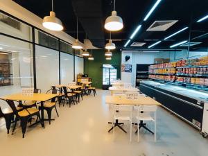 a restaurant with tables and chairs and a store at The Luxe Suite KLCC by Infinitum in Kuala Lumpur