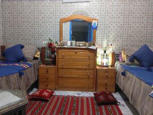 a living room with a dresser and a mirror at Chez Faiza in Rabat +11 photos