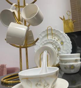 a pile of plates and bowls on a table at Heavenly stay in Ajman 