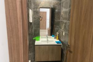 a bathroom with a sink and a mirror at Appartement Moderne et Équipé Proche Aéroport CMN in Nouaseur +9 photos