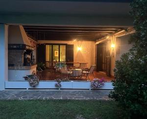 a house with a patio with a table and chairs at L'Angolo Verde in Roveredo in Piano