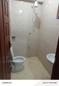 a bathroom with a toilet and a sink at Prift Royal Apartments in Meru +5 photos