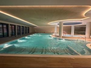 a large indoor swimming pool in a building at Luxurious apartment near the sea in Pobierowo in Pobierowo