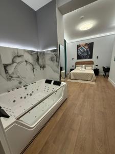 a bedroom with a large bed and a wall with a painting at Ventura Luxury in Alicante