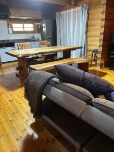 a living room with a couch and a wooden table at ISE Family Cabin in Ise