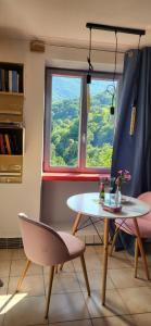 a table and chairs in a room with a window at Gîtes chez Daniel "Appartement Cevennes" in Mars