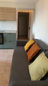 a couch with three pillows on it in a kitchen at Al Campanaro, Romantic retreat in the village in Castelluccio Superiore