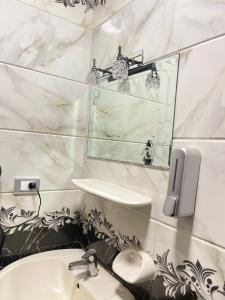 a bathroom with a sink and a mirror at B&KHOME Banha in Banī Ghālib