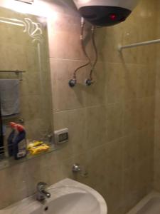 a bathroom with a shower and a sink and a mirror at بورتو السخنه الحدائق المعلقه in Ain Sokhna +7 photos
