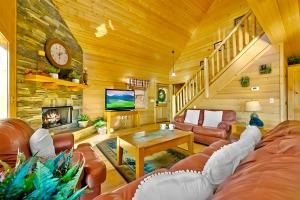 a living room with a couch and a fireplace at Little Cub Cabin I Spacious Exquisite View 3 King Hot Tub & BBQ in Sevierville