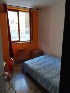 a bedroom with a bed and a window at Al Castello 2 in Bari