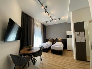 a hotel room with two beds and a table at Dream & Relax Apartment's Burg in Nürnberg