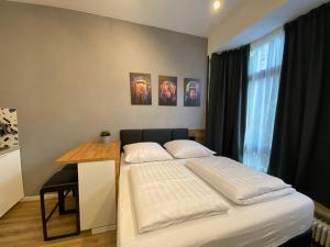 a bedroom with a bed and a table and a window at Dream & Relax Apartment's Burg in Nürnberg