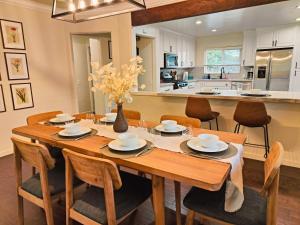 a kitchen and dining room with a wooden table and chairs at Old Fig House - Historic Fig Garden Neighborhood in Fresno