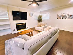 a living room with a couch and a tv at Old Fig House - Historic Fig Garden Neighborhood in Fresno