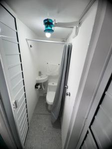 a small bathroom with a toilet and a blue light at La Casona Xalapa, céntrica y lugar muy tranquilo in Xalapa
