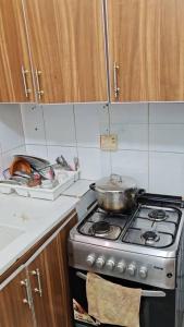 a kitchen with a stove with a pot on it at Oumou et Aicha in Dakar +23 photos