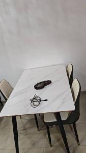 a white table with a pair of glasses on it at Oumou et Aicha in Dakar