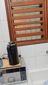 a coffee pot sitting on top of a microwave at Oumou et Aicha in Dakar