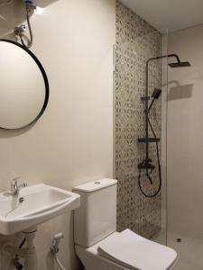 a bathroom with a toilet and a sink and a shower at Apartment in Sanur Harbour in Sanur