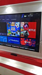 a flat screen tv on a wall at Oumou et Aicha in Dakar