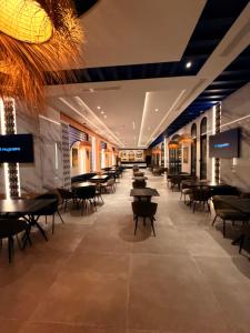 a restaurant with tables and chairs in a room at Diar Ayoub in Chebba
