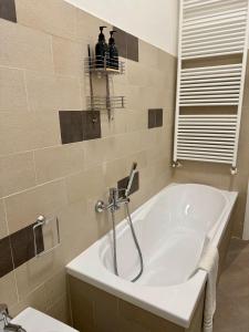 a white bath tub in a bathroom with a window at Casa Gien in Ferrara