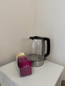 a coffee pot and a box of food on a counter at Casa Gien in Ferrara