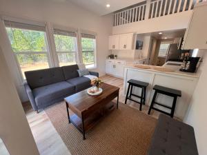 a living room with a couch and a table at Tiny House Village Yosemite-Blanca in Groveland