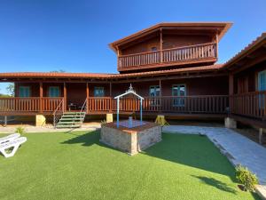a large house with a playground in the yard at Hacienda el Capricho in Cartaya