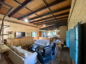 a living room with white couches and a television at Hacienda el Capricho in Cartaya