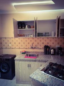 a kitchen with a sink and a stove in it at les Belles Résidences de Safir 2 in Tangier +31 photos