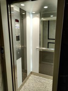 a elevator in a building with a glass door at les Belles Résidences de Safir 2 in Tangier