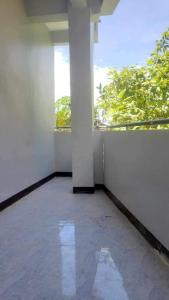 an empty room with a white wall and a window at Rest House Studio Room302 in Cebu City