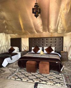 a bedroom with a bed in a tent with at Great Luxury Camp in Merzouga