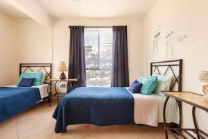 a bedroom with two beds and a window at Casa GOGA in Oaxtepec +101 photos
